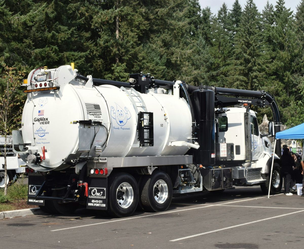 A white vacuum truck parked outdoors