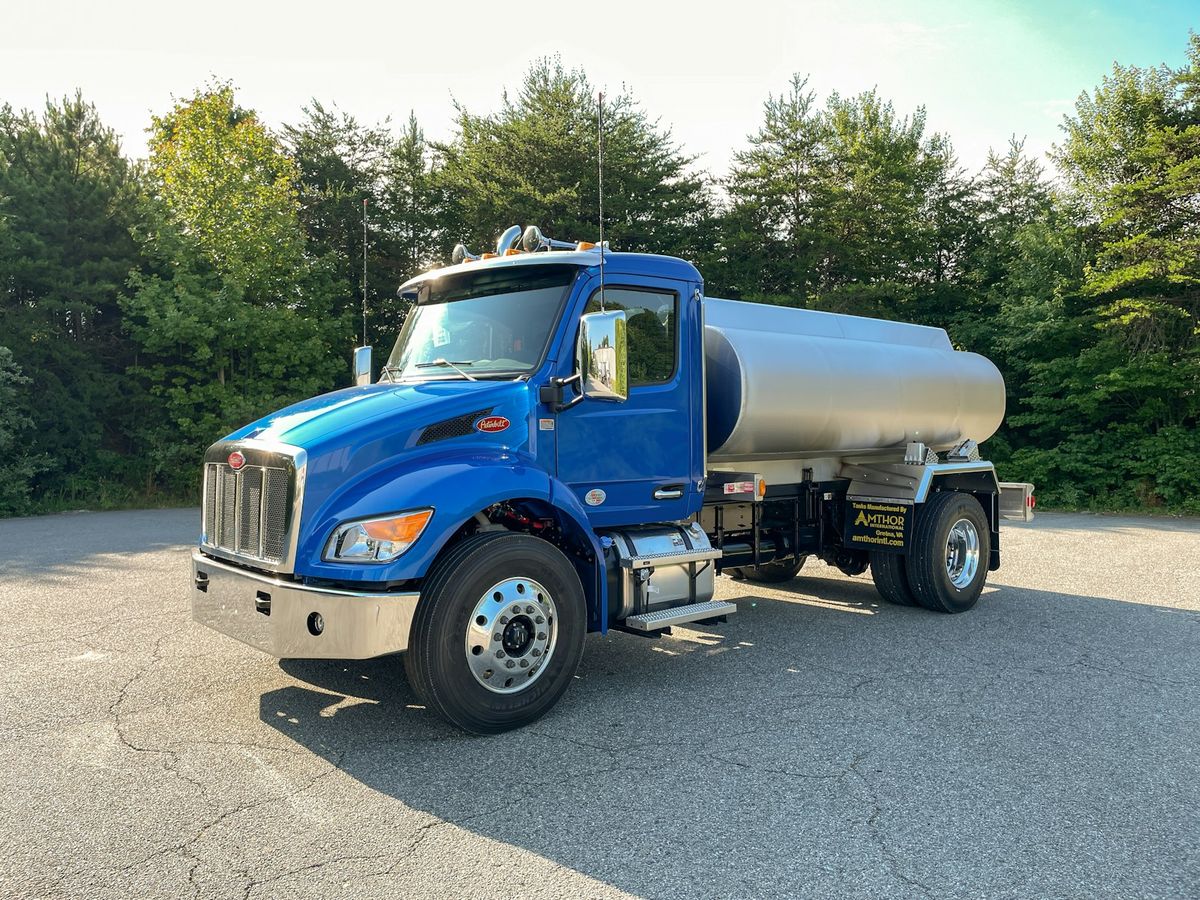 A blue tank truck parked in a lot